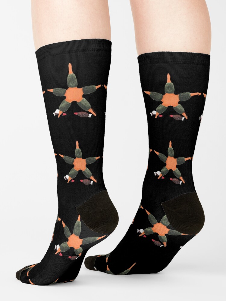 Feet with black socks and starfish wrapped in sushi greens