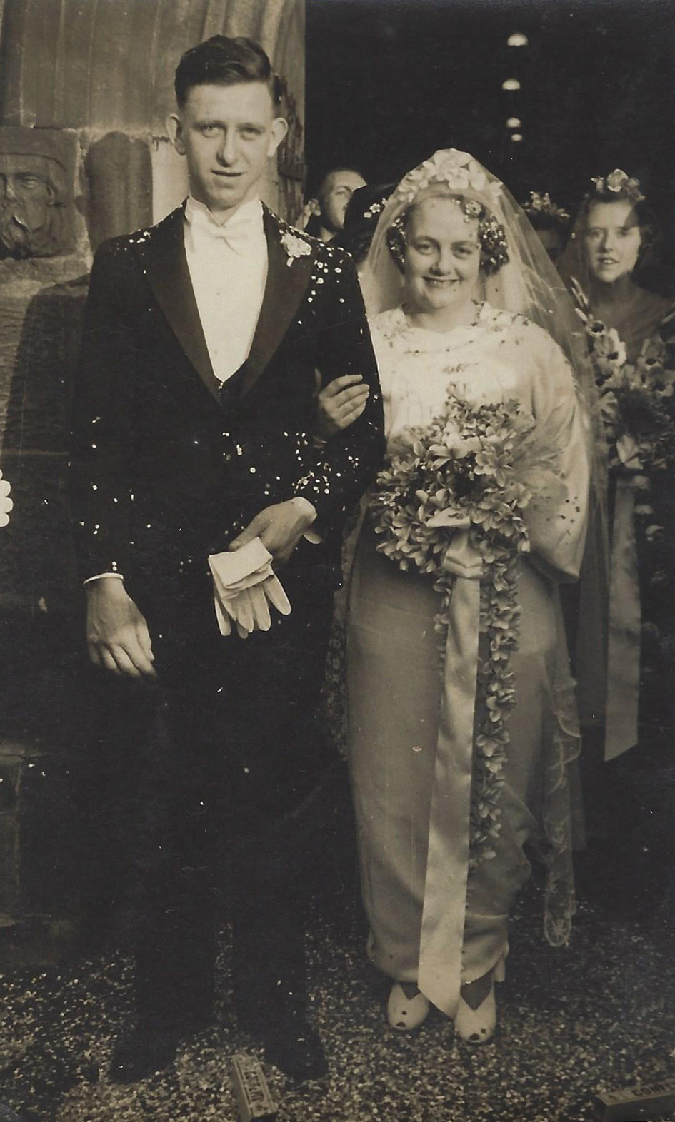 A newly-married man and woman exiting a church in 1938